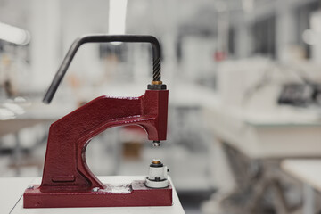 Close-up view of a Red Hand Press, practical eyelet machine