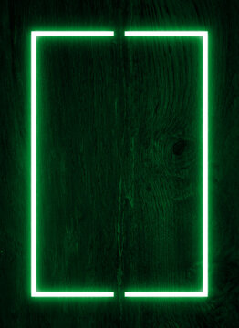 Dark wood wall background, green neon light and rectangle shape with vertical banner.