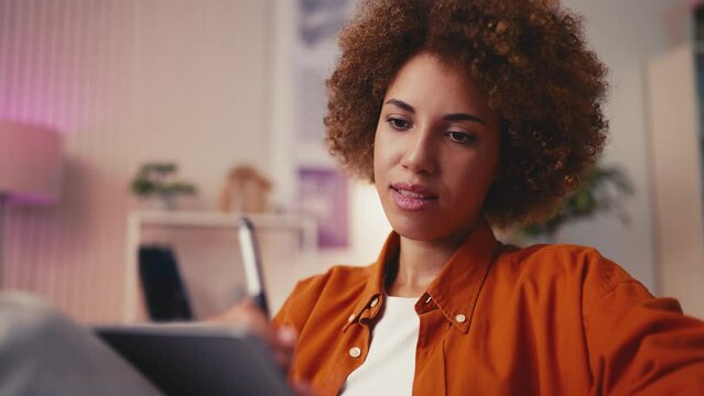 Happy African American illustrator designing new book cover on a graphic tablet