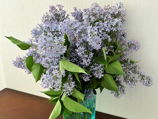 Bouquet of lilacs in a vase on the table. International Women's Day. International Lilac Day