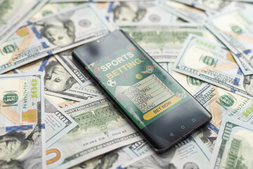 Smartphone with gambling mobile application with money close-up. Sport and betting concept - obrazy, fototapety, plakaty