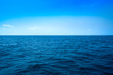 Ocean sea background and the clear sky For summer vacation ideas Nature of summer sea water with sunlight The sea sparkles against the blue sky.