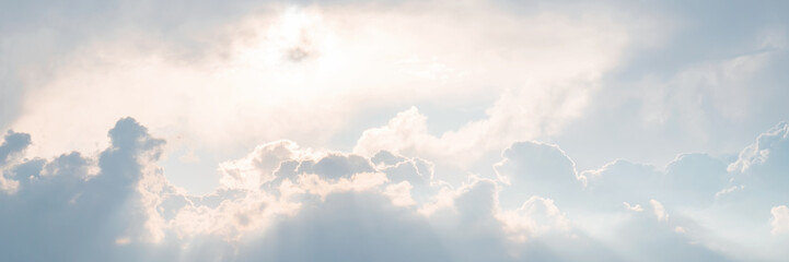 Beautiful sky background with clouds and sunbeams. Dramatic cloudscape with sun rays. Bright...