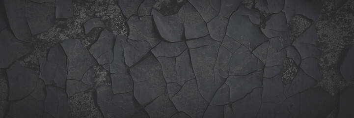 Dark wide panoramic background. Peeling paint on a concrete wall. Faded dark texture of old cracked flaking paint. Weathered rough painted surface with patterns of cracks. Shaded background for design - 777057604