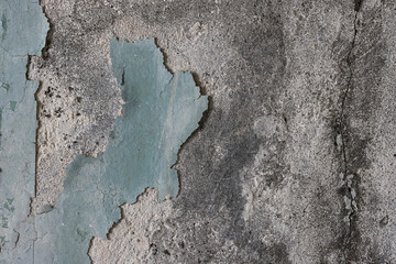 Peeling paint on the wall. Old concrete wall with cracked flaking paint. Weathered rough painted surface with patterns of cracks and peeling. High resolution texture for background and design. Closeup - 777058005