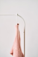 A woolen sweater hanging on a hanger on a white background. Warm clothes sale. Concept - everything is sold out in a clothing store.