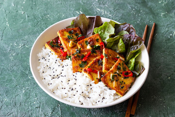 Fried tofu with rice and salad. Vegetarian food. Healthy eating. Diet.