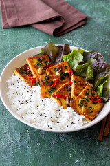 Fried tofu with rice and salad. Vegetarian food. Healthy eating. Diet.