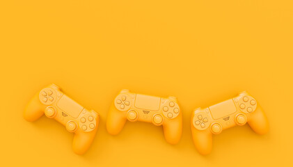 Video game joysticks or gamepads in plain monochrome yellow color background © Vasyl Onyskiv