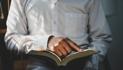 Man praying and reading the Bible On hand for prayer meeting Religious concepts.