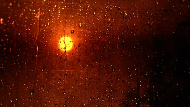 Water Drops following down on black background. Drops of Rain trickling down isolated. Best 4K footage Droplets of Water on Black Glass running down. Perfect for digital composing.