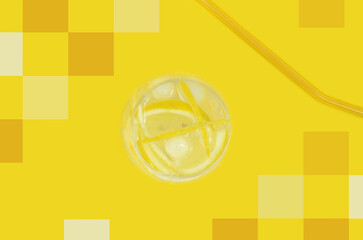 Yellow drink, cocktail with lemon, on yellow background with yellow geometric decoration (squares), top view, summertime. Photo mixed with graphics.