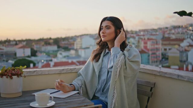 Dreamy woman writing diary resting sunset terrace closeup. Author creating book