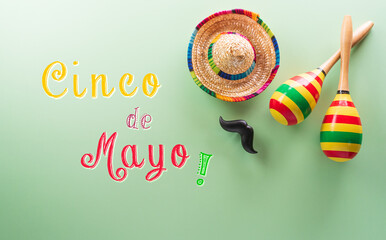 Cinco de Mayo holiday background made from maracas, mexican blanket stripes or poncho serape and hat on pastel background.