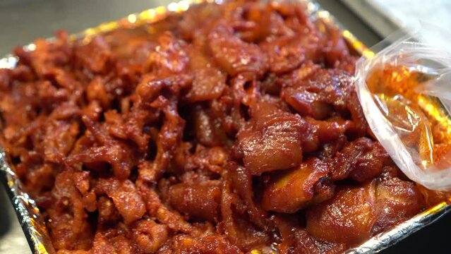 Stir fried bulgogi pork belly fat and meat with red Korean sauce local meak in korea market