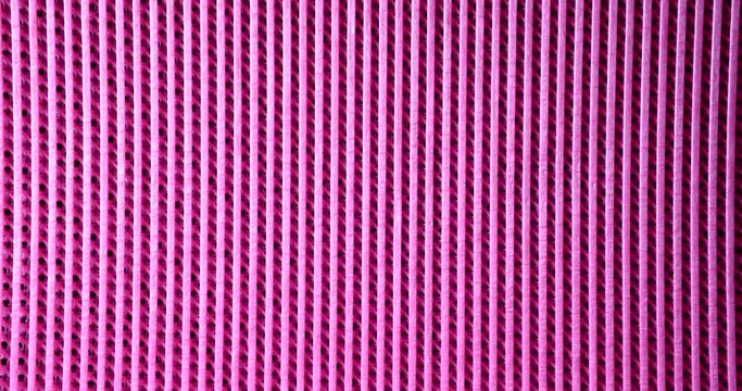 Pink rubber mat with parallel lines background closeup 4k movie slow motion. Abstract patterns for design concept