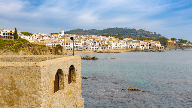 Calella de Palafrugell se despliega en esta panor&aacute;mica con sus edificios encalados y tejados color terracota frente al mar, con una antigua muralla en primer plano.