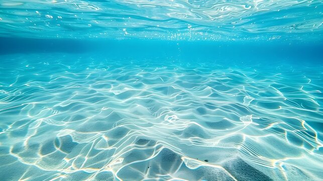 Photo of clear blue water, with light ripples and small waves on the surface, in shallow waters, with a view from above, looking down at the bottomless ocean.