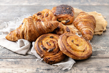 Set of bakery pastries on wooden table - obrazy, fototapety, plakaty