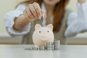 woman hand putting money coin into piggy for saving money wealth and financial concept, Stack of coins arranged together