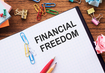 Financial Freedom concept. Financial freedom text on the notepad