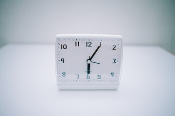 The work desk clock is placed on a white base in the form of a rectangular box. The clock shows...