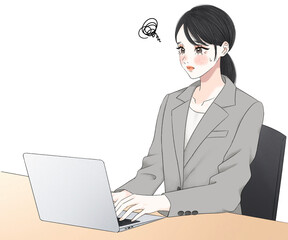 ノートパソコンの作業に悩むスーツ姿の女性