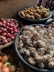 Fresh Garlic Onion Shallots Potato Herbs Organic Bulk Group Heap in a Pail Basket Container at the Traditional Market