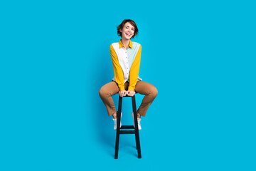 Photo of funny happy manager girl sit stool have relax in work day isolated over blue color...