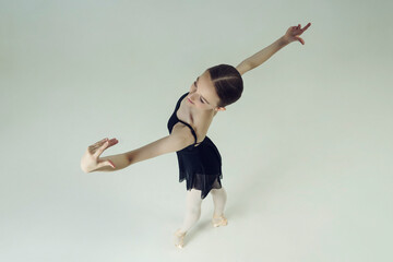 young teen ballerina posing in motion dance elements top view