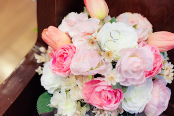 Wedding bouquet with wedding rings. They are beautiful symbols as happy wedding. 