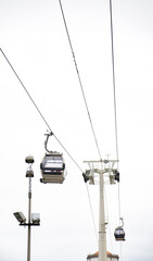 Two gondolas of the Vila Nova de Gaia cable car suspended on hanging steel cables with the...