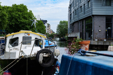 London - 06 03 2022: Views of houseboats on the Regent's Canal with the Whitmore Bridge in the background
