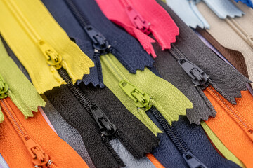 Multicolored Plastic Zippers or Zip Fasteners with sliders pattern for handmade sewing tailoring...