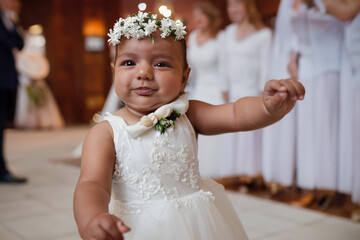 Cute little baby girl dancing on wedding, close-up