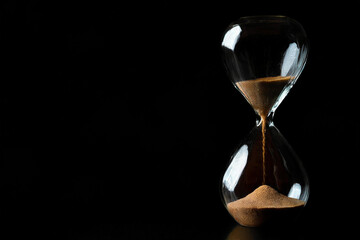 Hourglass on a black background.