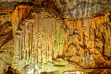 Dramatic organ pipe shape formed by stalactites in a large underground limestone Cango Caves near...