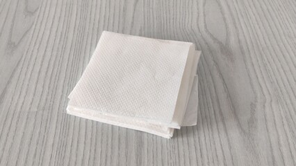 Stack of white paper napkins on the table