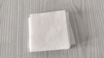 Stack of white paper napkins on the table