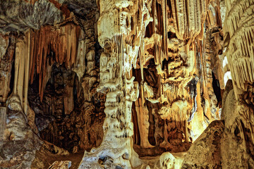 Sculpture like stalactite and stalagmite column in the large underground limestone Cango Caves near...