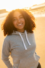 African American Girl Teenager Smiling on a Beach at Sunset - 777171014