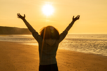Female Woman Girl Arms Raised on an Empty Beach at Sunset - 777182057