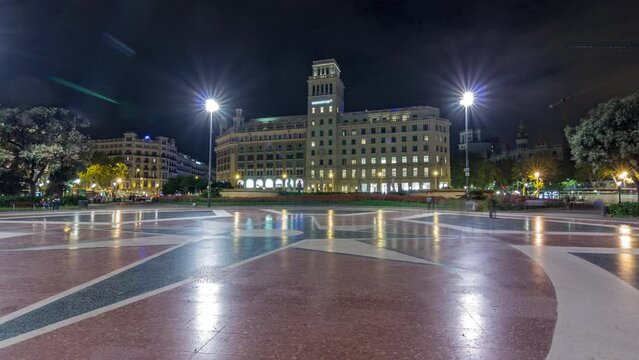 Timelapse Hyperlapse of Illuminated Placa de Catalunya in Central Barcelona. A Large Square Regarded as the City Center, Featuring a Central Fountain and Flowerbed as a Backdrop to the Nightly Bustle