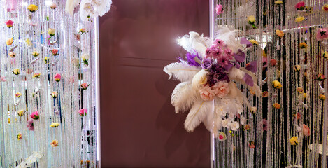 A pink wall with a decorative centerpiece that resembles a pedestal. The wall is decorated with...