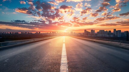 empty road with panoramic cityscape at sunset