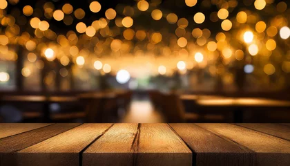  empty wood table top on blur light gold bokeh of cafe restaurant in dark background © netsay
