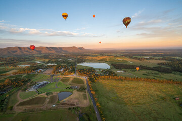 Hot air balloons in Pokolbin wine region, aerial landscape at sunrise, Pokolbin, Hunter Valley,...
