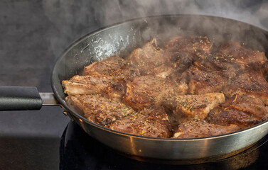 Lamb chops frying on the pan