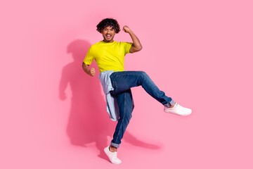 Photo of carefree glad nice man wear stylish yellow clothes shout yes hooray isolated on pink color background