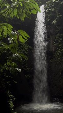 Beautiful Tibumana Waterfall on nature background. Bali, Indonesia 
